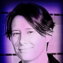Photo of face with slight smile, recolored with a high-contrast indigo filter.